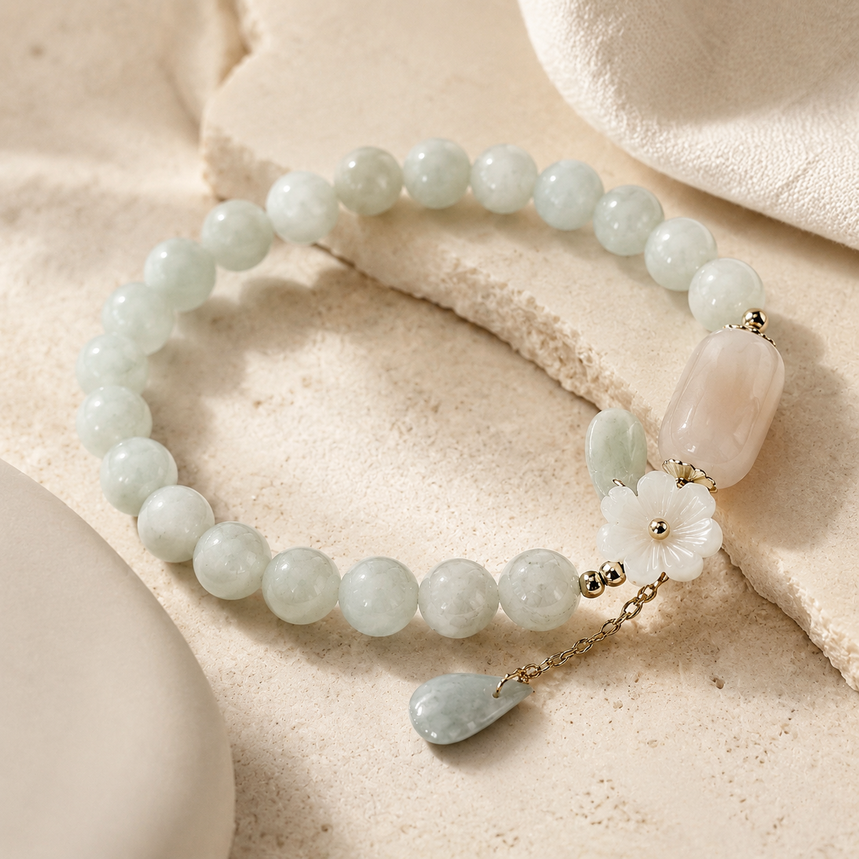 Close detail of the shell flower jade bracelet and dangle.