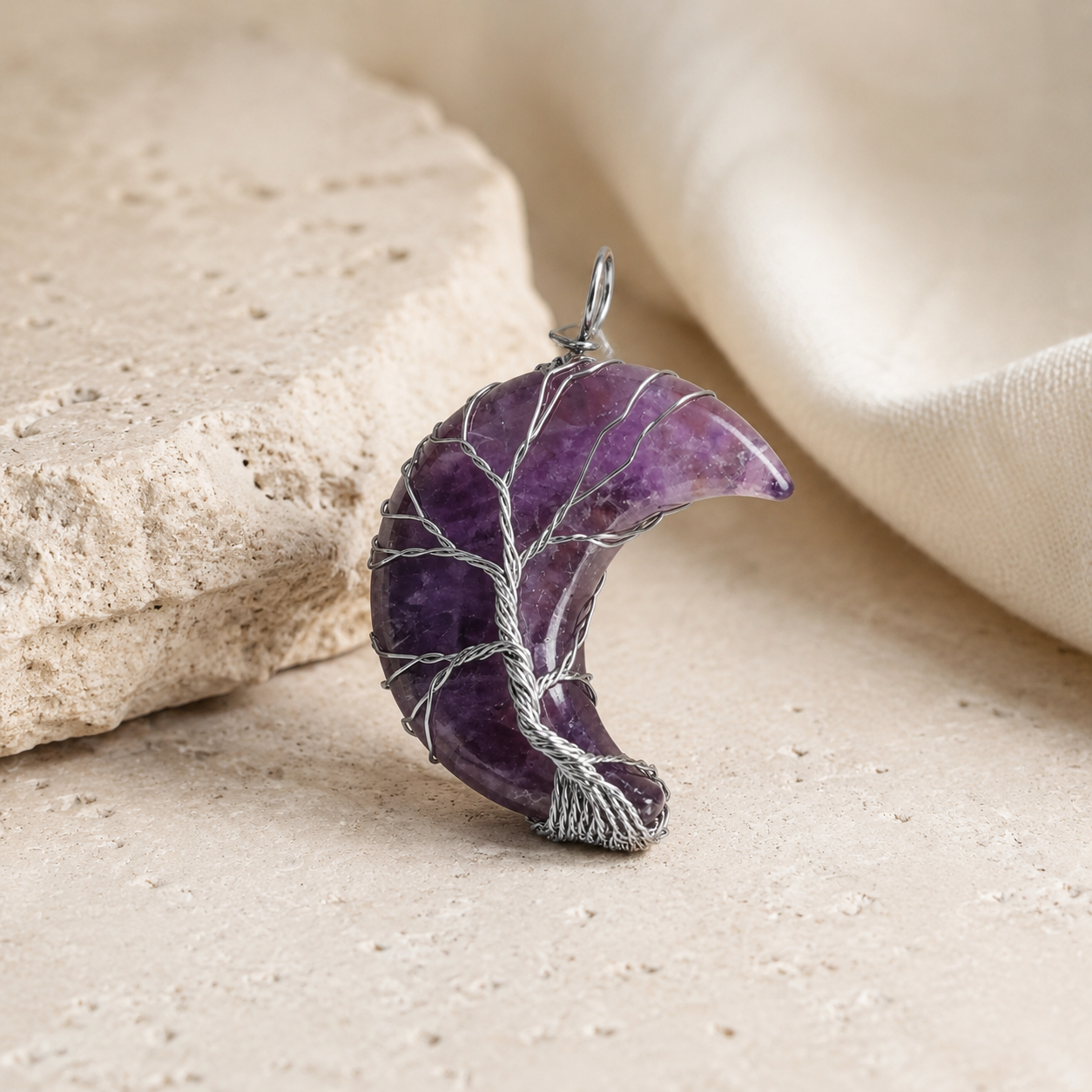 Close detail of the purple amethyst moon pendant necklace.